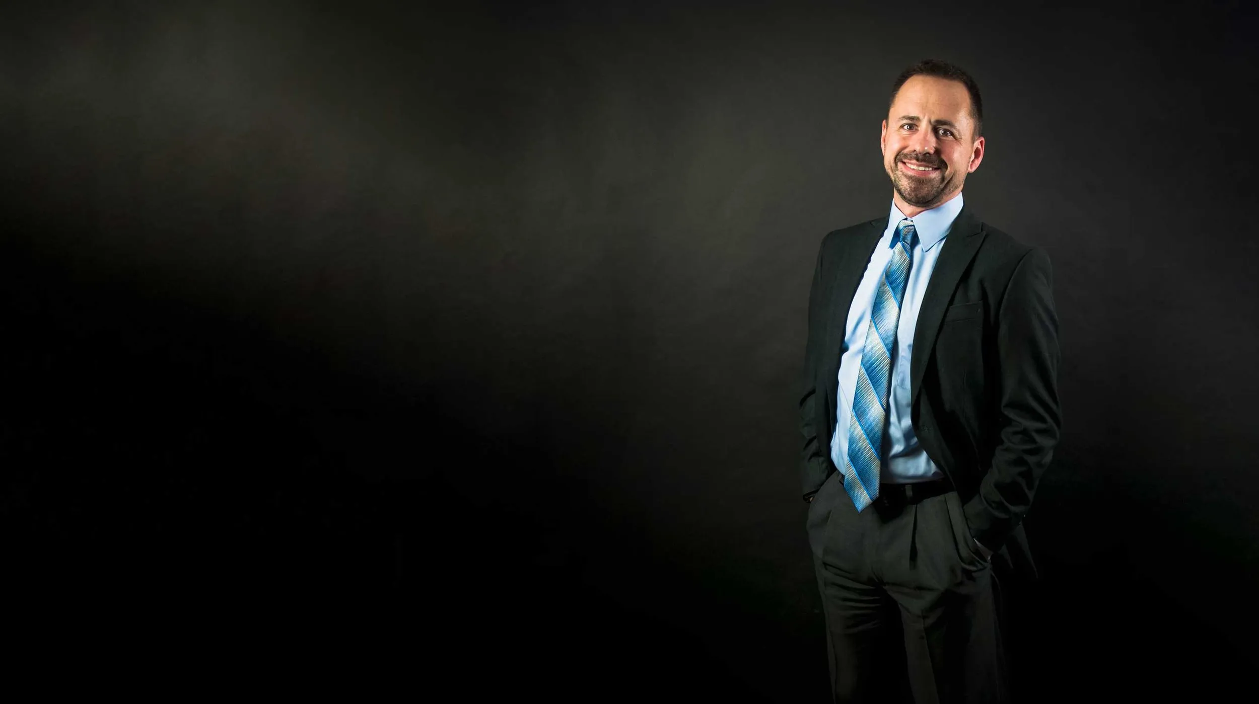 Dr. Frank M. Sorokach in a dark suit and blue tie