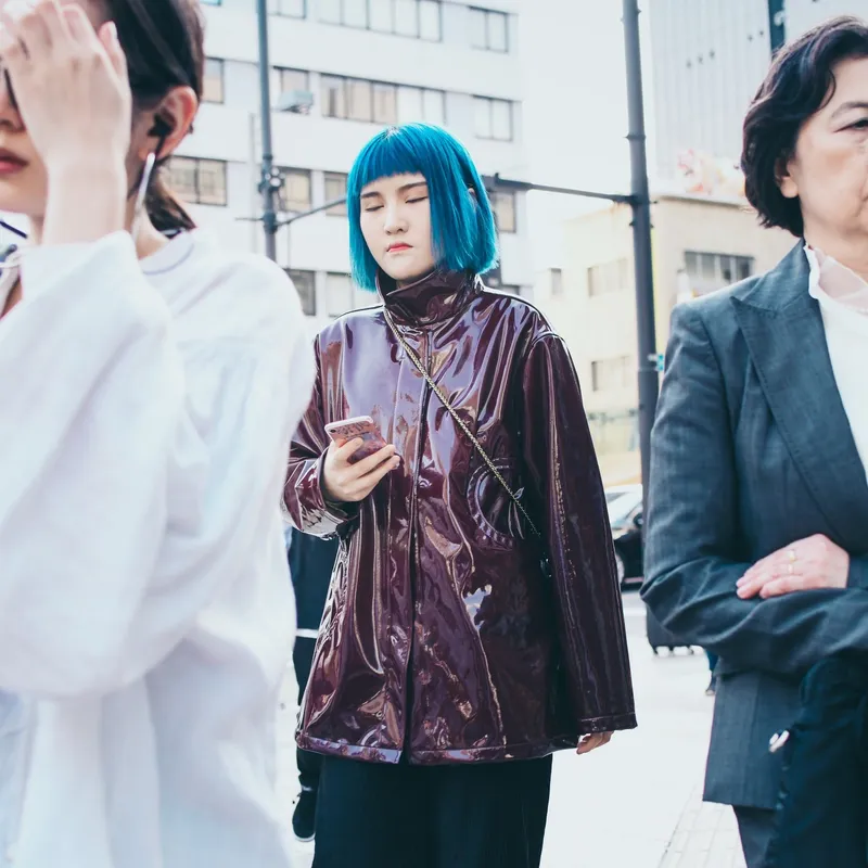 Three women of different generations standing side by side
